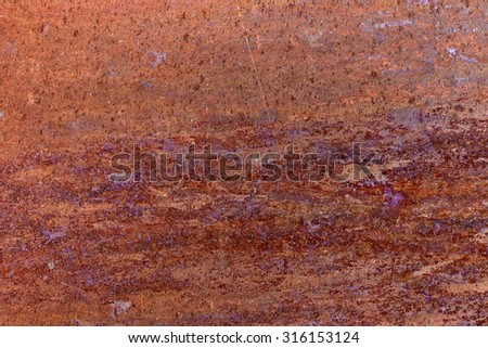 Rusty metal plate etched by corrosion