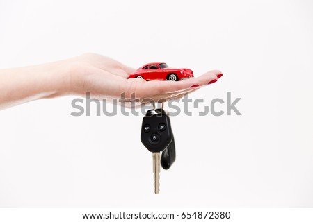 Car purchase concept. Toy car on woman's palm, car keys on finger Foto stock © 