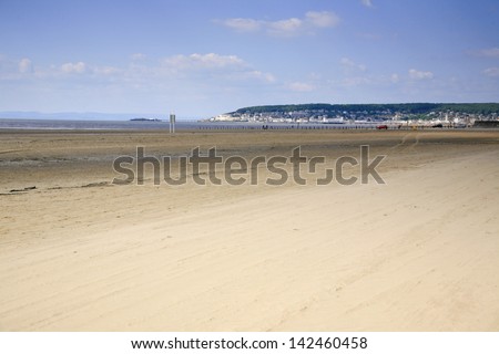 Weston Super mare beach with views of the Grand pier, the old Birnbeck pier and Worlebury hill