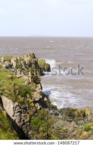Waves crashing onto the rocks at the tip of Sand point in Somerset