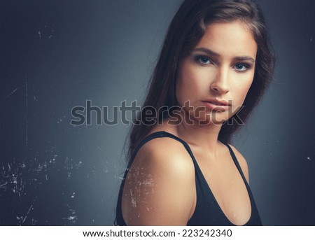 beautiful woman studio portrait in dark light with old effect and classic light