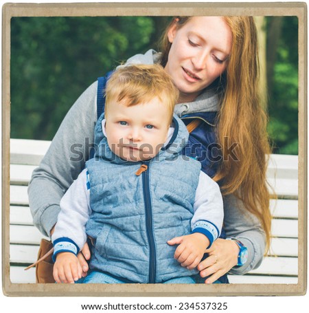 Family  mother with child in park walking in same clothes textile jeans jacket