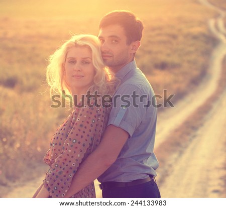 Happy people outdoors beautiful landscape and couple in love with flowers on sunset happy people outdoor
