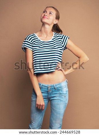 Young beautiful woman studio portrait in jeans and check  clothes
