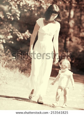 Family happy outdoors black and white vintage mother with child playing