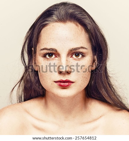 Portrait of fun attractive girl woman with freckles clear skin and beautiful hair