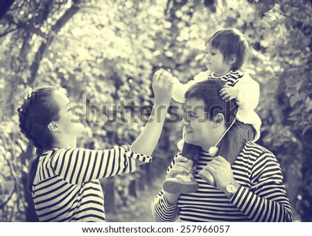 Family with child father and mother in same stripes clothes vintage black and white nature