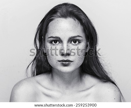 Woman  face freckled young beautiful healthy skin and long hair portrait black and white