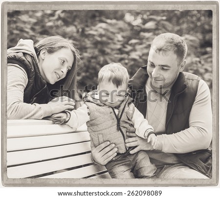 Family parents playing with child vintage card