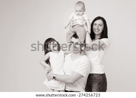 Happy beautiful family 4 people with new born baby parents sister brother portrait