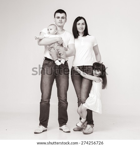 Happy beautiful family 4 people with new born baby parents sister brother portrait