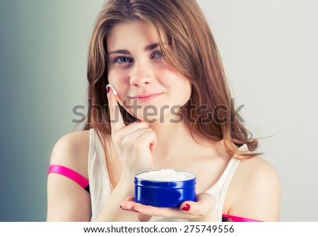 Portrait of girl woman with problem and clear skin creme, aging and youth concept  touching face with cream