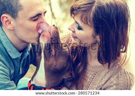 Couple in love with dog nature dog licking man