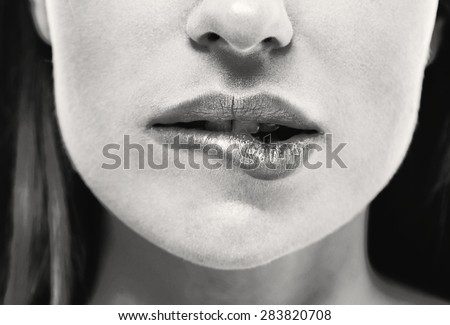 Woman bite lips close up face beautiful black and white