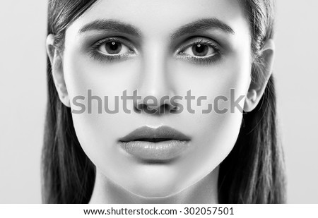 Beautiful woman face close up studio on white black and white