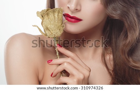 Beautiful woman young model with red lips and red manicure gold rose flower eyeshadows isolated on  white