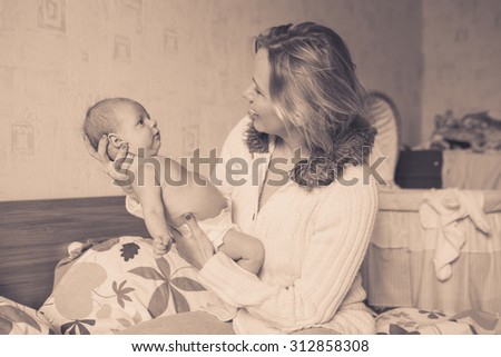 Mother with her newborn baby care vintage