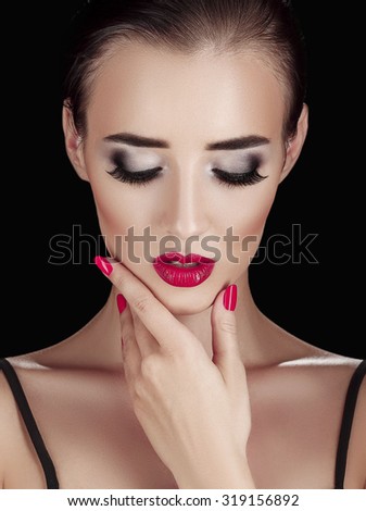 Beauty Woman with Perfect Makeup. Beautiful Professional Holiday Make-up. Red Pink Lips and Nails. Beauty Girl\'s Face isolated on Black background