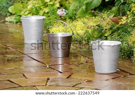 Three Metal buckets in the Rain