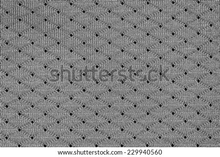 White sportswear fabric with holes texture closeup photo background.