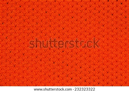 Orange sportswear fabric texture closeup photo background.