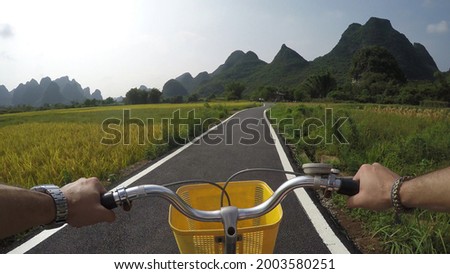 First person view cycling in Yangshuo County China very popular chinese tourist destination for both foreign as domestic tourists area is known for the karst peaks mountains 4k high resolution 商業照片 © 