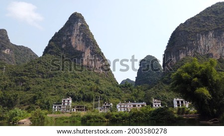 View of Yangshuo mountains in China very popular chinese tourist destination for both foreign as domestic tourists area is known for the karst pointy peaks mountains 商業照片 © 