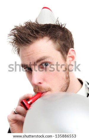 Party guy with partyhat and party blower. Wearing a suit. White background.