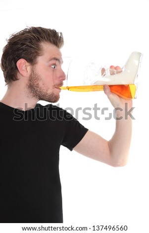 Man with a boot shaped beer glass wearing a black t-shirt. White background.