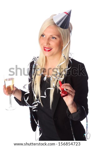 Attractive woman wearing a black party dress, party hat and streamers. Holding a champagne glass and blower. White background.
