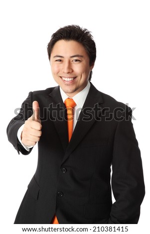 Attractive businessman in a suit and tie, doing thumbs up. White background.