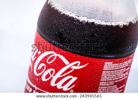 SABAH, MALAYSIA - JANUARY 13, 2015. bottle of Coca-cola drink isolated on white. The Coca-Cola can, which dates back to 1915, is the most recognised packaging in the world today.