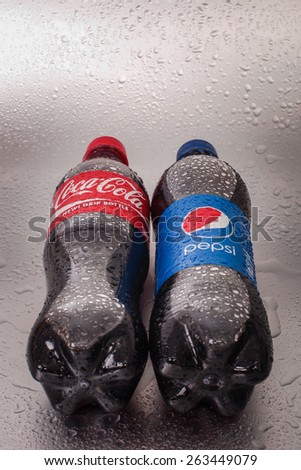 SABAH, MALAYSIA - March 08, 2015: Coca-Cola and Pepsi bottle on metal background.