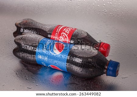 SABAH, MALAYSIA - March 08, 2015: Coca-Cola and Pepsi bottle on metal background.