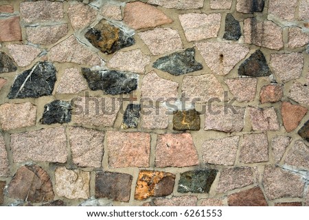 wall built from small natural granite stones and concrete