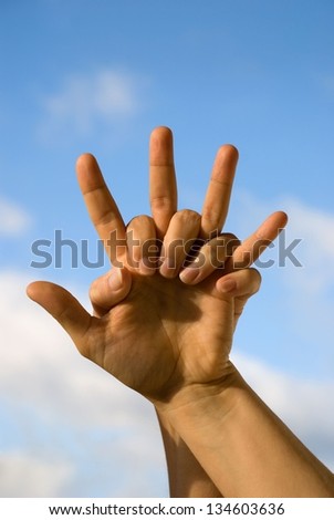 two cheering hands in front of the sky
