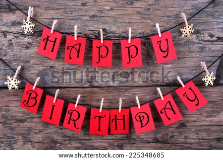 Red Tags Hanging on a Line with the Words Happy Birthday on it, Wooden Background