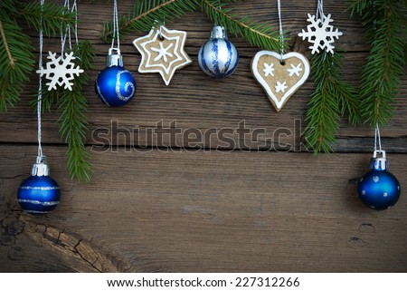 Christmas Balls, Ginger Breads, Snowflakes and Fir Tree Branches Hanging on Wood with Copy Space, Christmas or Winter Background