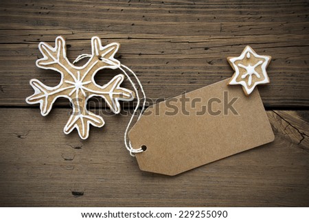 Empty Banner with Space for Your Text and a decorated Ginger Bread Snowflake and a Star, Wooden Background