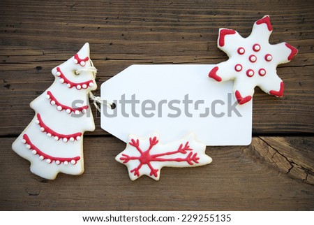 Empty Label with Copy Space, decorated with Red and White Christmas Cookies, on Wood