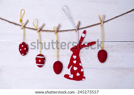 A Red Easter Bunny With Hearts Hanging On A Line With Four Red Easter Eggs Which Are Dotted And Striped On White Wooden Vintage Or Rustic Background For Easter Greetings And Happy Easter