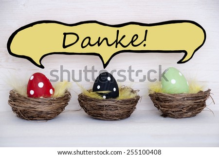 Three Colorful Dotted Easter Eggs In Easter Baskets Or Nest On White Wooden Background With Comic Speech Balloon With German Text Danke Means Thank You Used As Easter Decoration Or Easter Greetings