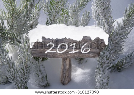 Wooden Christmas Sign With Snow And Fir Tree Branch In The Snowy Forest. Text 2016 For Seasons Greetings Or Happy New Year Greetings. Christmas Atmosphere.