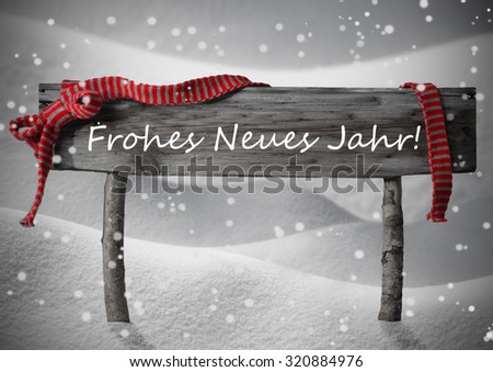 Gray Wooden Christmas Sign On White Snow. Snowy Scenery, Snowflakes. Red Ribbon, GermanText Frohes Neues Jahr Mean Happy New Year. Christmas Decoration, Card. Rustic Or Vintage Syle.