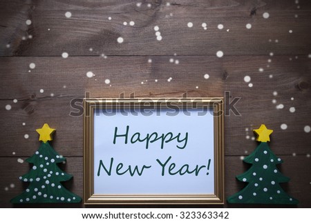 One Golden Picture Frame With Two Green Christmas Tree. English Text Happy New Year. Christmas Card For Seasons Greetings. Decoration With Brown Wooden And Rustic Retro Background With Snowflakes