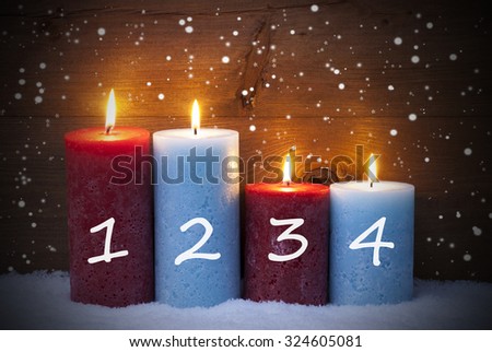 Christmas Decoration With Red And Blue Candles. Four Candle For Advent With Numbers 1, 2, 3, 4. Peaceful, Romantic Atmosphere With Candlelight And Snowflakes. Wooden, Vintage, Rustic Background.