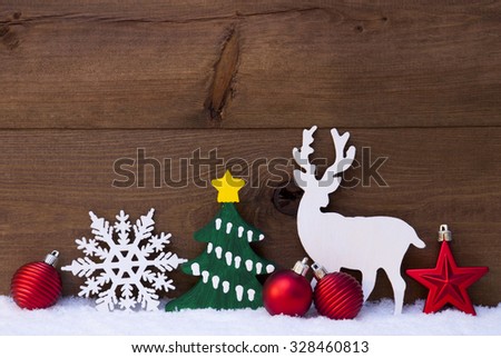 Christmas Decoration With Reindeer On White Snow. Green Christmas Tree, Snowflake And Red Christmas Balls. Brown, Rustic, Vintage Wooden Background For Copy Space. Christmas Card With Snowy Atmosphere