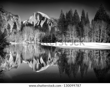 Black and white view of half dome reflected in the Merced river at Yosemite National Park