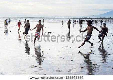 KUTA, INDONESIA - APRIL 4: Unidetified people plaing soccer on  April 4, 2011 in Kuta, Indonesia. Football is the most popular sport in Indonesia. The Indonesian football league started around 1930