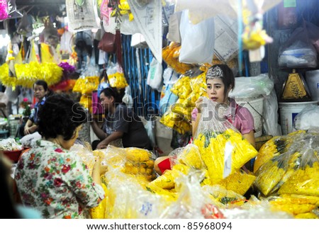 BANGKOK, THAILAND - MARCH 25: Seller at local market in Bangkok Chinatown on March 25, 2011 in Bangkok, Thailand. Bangkok  Chinatown is a popular tourist attraction and a food haven